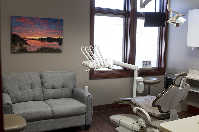 Lakewinds Dental Centre examination room complete with a sunset portrait on the wall and a couch to relax on